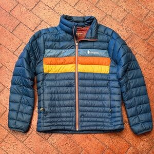 Cotopaxi Men's Dark Blue Fuego Jacket with Orange and Yellow Stripes